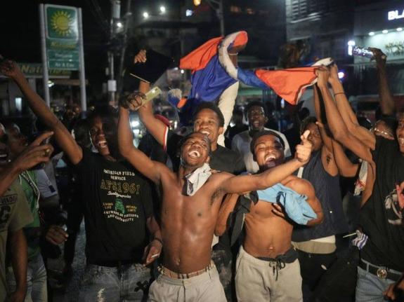 Fans celebrate Haiti's qualification for the 2026 FIFA World Cup after a football match against Nicaragua, in Port-au-Prince, Haiti, Tuesday, November 18, 2025. (AP Photo/Odelyn Joseph)