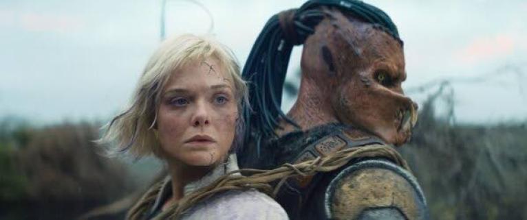 This image released by 20th Century Studios shows Thia portrayed by Elle Fanning (left) and Dek portrayed by Dimitrius Schuster-Koloamatangi in a scene from ‘Predator: Badlands’.