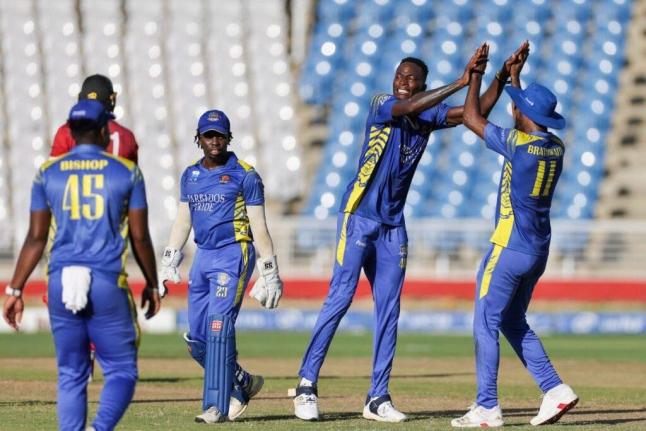 Photo by CWI Media 
Dominic Drakes (second right) celebrates one of his four wickets against the Trinidad and Tobago Red Force during the final of the CG United Super50 cricket competition at the Brian Lara Cricket Academy yesterday.