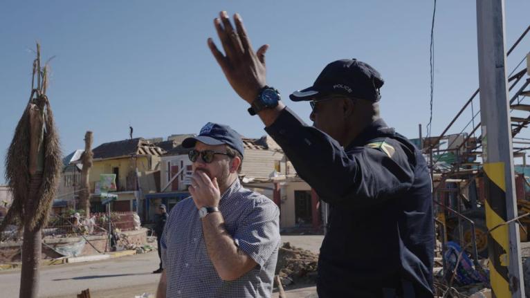 UK Minister for the Caribbean, Chris Elmore (left) surveys the devastation in Black River, with head of the St Elizabeth Police Division, Superintendent Coleridge Minto.