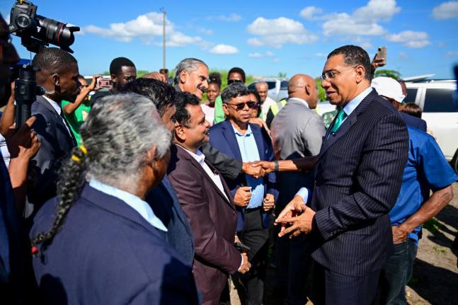 Prime Minister Dr Andrew Holness (right) greets shareholders of the Tropical Sugar Company Limited ahead of the ceremony to break ground for the new sugar factory in Chesterfield, Clarendon, on December 2.