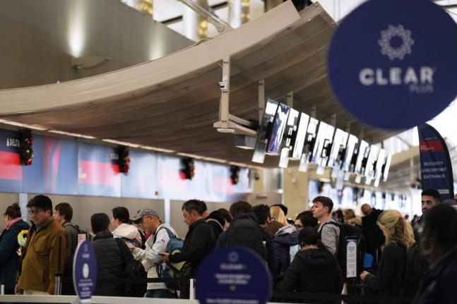 Travellers wait in a TSA checkpoint at Detroit Metropolitan Wayne County Airport Wednesday, November 26, 2025, in Romulus, Mich. (AP Photo/Ryan Sun)
