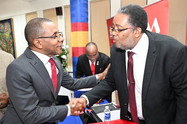 Professor Michael Taylor (right), dean of the Faculty of Science and Technology at the University of the West Indies (UWI) Mona, is greeted by Courtney Campbell, CEO of the VM Group, at the UWI MONA/VM GROUP Distinguished Lecture held on Thursday at the UW