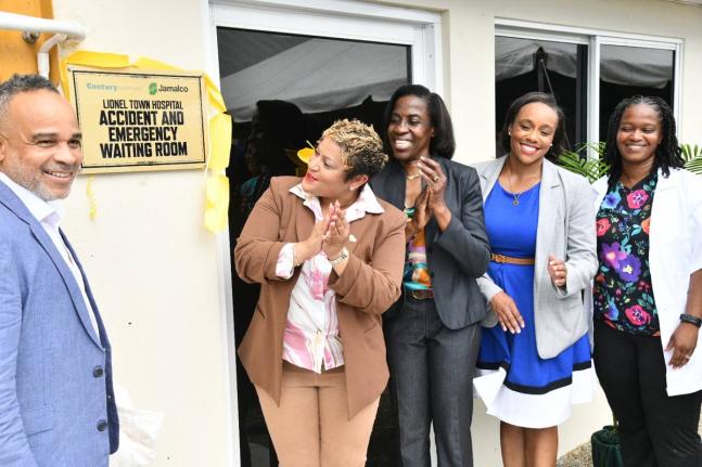 Minister of State in the Ministry of Health and Wellness, Krystal Lee (second left), applauds as she views the plaque dedicating the newly renovated Accident and Emergency Waiting Area at the Lionel Town Hospital in Clarendon, at the official opening of th