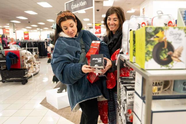 Becca Mendoza and Tammi Hines look at products as shoppers browse through Kohl’s department store for Black Friday deals, Friday, Nov. 28, 2025, in Woodstock, Ga. (AP Photo/Megan Varner)