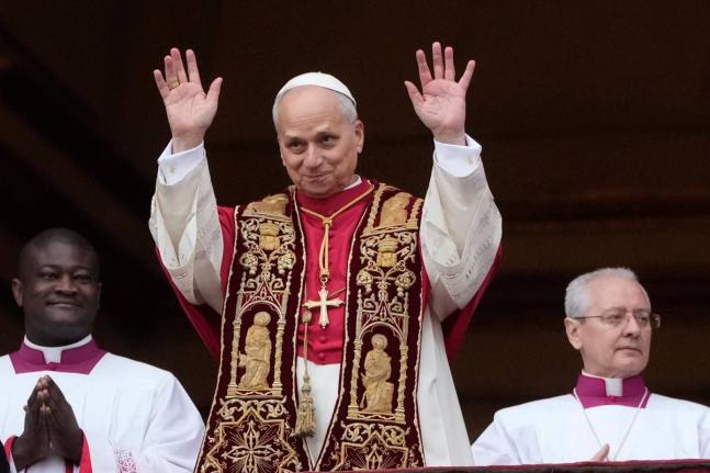 Pope Leo XIV waves after delivering the Urbi et Orbi (Latin for 'to the city and to the world' ) Christmas' day blessing from the main balcony of St. Peter's Basilica at the Vatican, Thursday, December 25, 2025. (AP Photo/Gregorio Borgia)