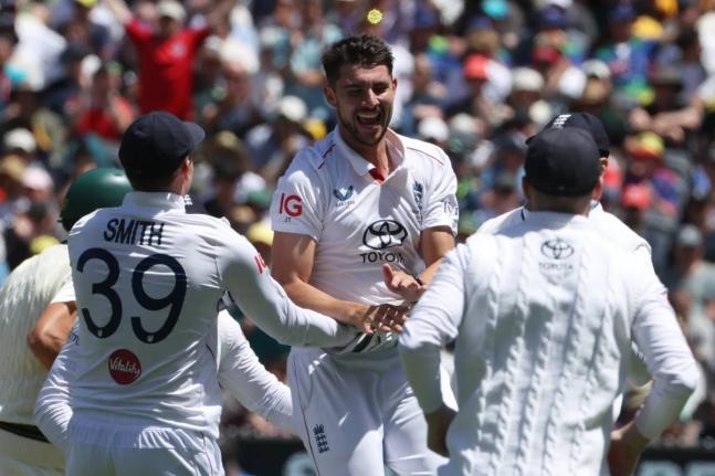 England’s Josh Tongue (centre)  celebrates with teammates after taking the wicket of Australia’s Scott Boland during their Ashes cricket Test match in Melbourne yesterday.