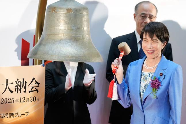 Japan’s Prime Minister Sanae Takaichi poses before ringing the bell during a ceremony to mark the last trading day of the year on the Tokyo Stock Exchange on Tuesday, December 30 in Tokyo. 