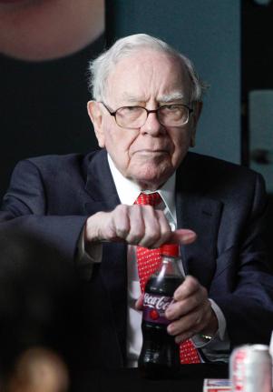 Warren Buffett, outgoing CEO of Berkshire Hathaway, opens a bottle of Cherry Coke during a game of bridge outside Berkshire-owned Borsheims jewellery store in Omaha, Nebraska, USA. 