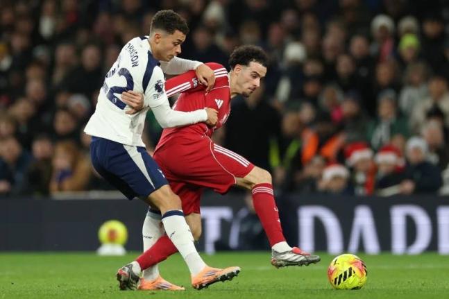 Tottenham’s Brennan Johnson (left) duels for the ball with Liverpool’s Curtis Jones during the English Premier League  match between Tottenham and Liverpool in London, Saturday, December 20, 2025. 