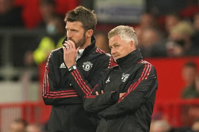 Manchester United’s manager Ole Gunnar Solskjaer (right) and his assistant Michael Carrick stand on the touchline during an English League Cup football match against West Ham at Old Trafford in Manchester, England, on September 22, 2021.