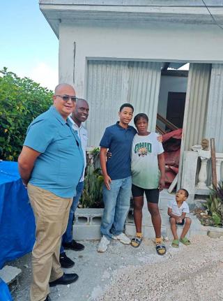 Abraham Azan (centre), founder of Beyond Youth Jamaica, following his donation of building material to Shana Folkes (fourth from left) in Ritchies, Clarendon. Looking on from left are Abraham’s grandfather, Richard Azan, member of parliament for Clarendo