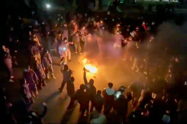 In this frame grab from footage circulating on social media shows protesters dancing and cheering around a bonfire as they take to the streets despite an intensifying crackdown as the Islamic Republic remains cut off from the rest of the world, in Tehran, 