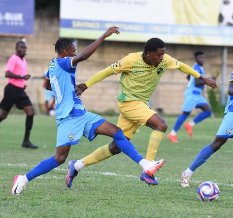 Treasure Beach FC’s Karim Bryan (right) evades a tackle from Molynes United’s Rashawn Livingston during their Jamaica Premier League football match at Drewsland yesterday. Treasure Beach FC’s Karim Bryan (right) evades a tackle from Molynes United’