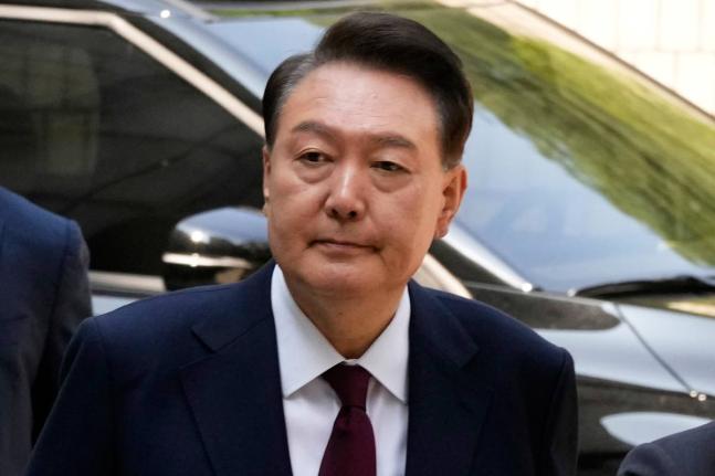 Then South Korea's ousted former President Yoon Suk Yeol who is facing charges of orchestrating a rebellion when he declared martial law on December 3, arrives to attend his trial at the Seoul Central District Court in Seoul, South Korea on May 12, 2025.
