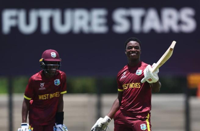 West Indies U19 batsman Shamar Apple (right) celebrates a century against Japan, while Tanez Francis, who also scored a hundred, looks on during an ICC U19 Cricket World Cup warm-up game at the United Cricket Ground in Windhoek, Namibia, yesterday.