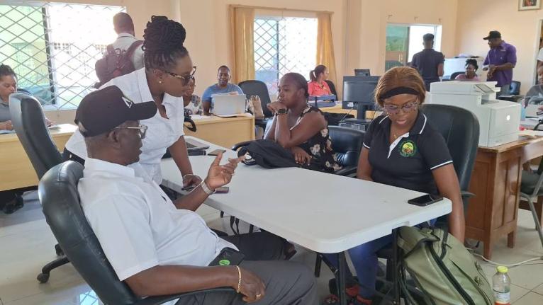 Local Government Minister Desmond McKenzie (left) in discussion with employees of the St Elizabeth Municipal Corporation.