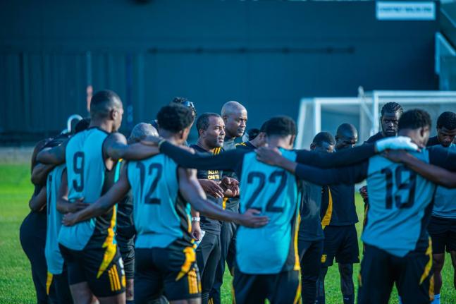 Reggae Boyz interim coach Rudolph Speid huddles with his charges during a training session at Sabina Park.
