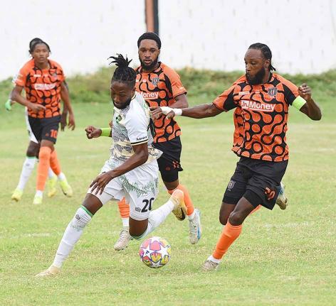 Treasure Beach’s Jhanni Flemmings (second left) looks to outrun Tivoli Gardens FC’s  Keno Simpson (right), Anthony Nelson (second right) and Nickalia Fuller during their rescheduled Jamaica Premier League football match at Edward Seaga Sports Complex o