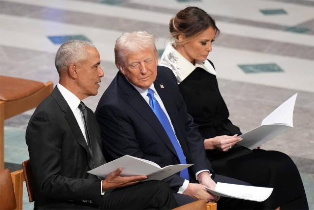 Former President Barack Obama talks with then President-elect Donald Trump as Melania Trump reads the funeral program before the state funeral for former President Jimmy Carter at Washington National Cathedral in Washington, January 9, 2025. (AP Photo/Jacq