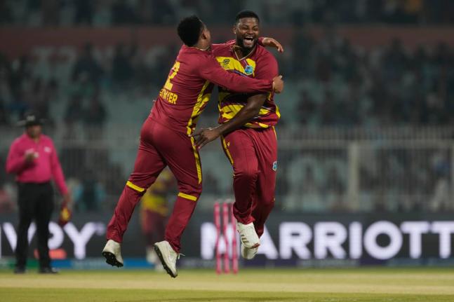 West Indies’ Romario Shepherd (right) celebrates the wicket of Scotland’s Safyaan Sharif with Shimron Hetmyer during their opening T20 World Cup cricket in Kolkata, India, yesterday.