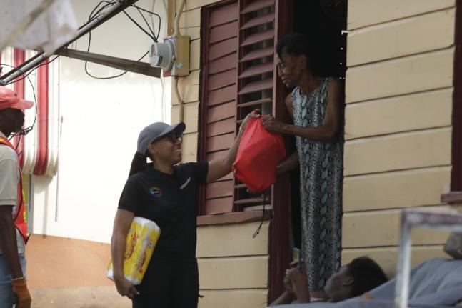  Imega Breese McNab (centre), corporate affairs manager and company secretary at Carreras, joined the team in providing emergency relief supplies to residents in Savanna-La-Mar, Westmoreland in the immediate aftermath of Hurricane Melissa.