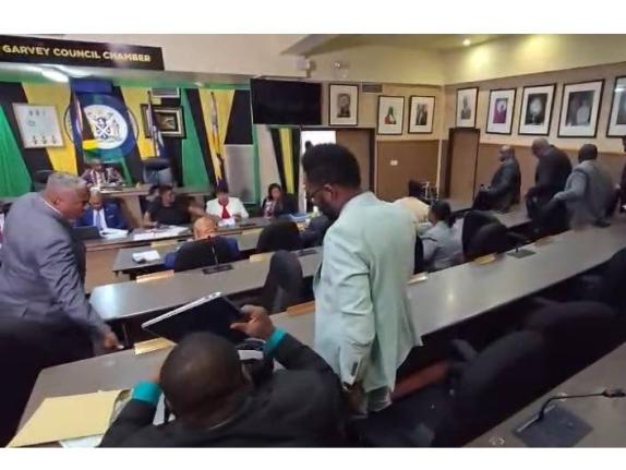 Jamaica Labour Party councillors on their feet as they staged a walkout at the monthly meeting of the Kingston and St Andrew Municipal Corporation on February 10.