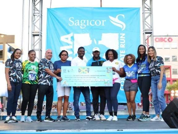 The 28th staging of the Sagicor SIGMA Corporate Run surpassed its target by raising $152 million under the theme “Run for the West”. The symbolic cheque presentation happened at the Knutsford Boulevard start line on February 15, 2026. (From left) Daidr