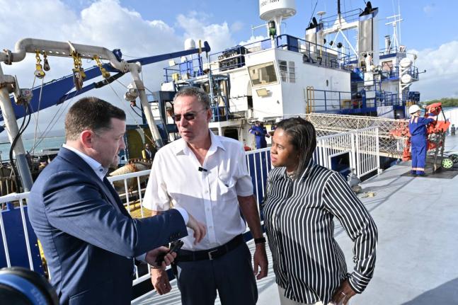 Daryl Vaz (centre), minister of science, energy, telecommunications and transport, and Kedesha Campbell Rochester (right), permanent secretary, chat with Brian Larken, CEO, United Oil & Gas, during a vessel tour of the ‘R/V Gyre’ as part of United Oil 