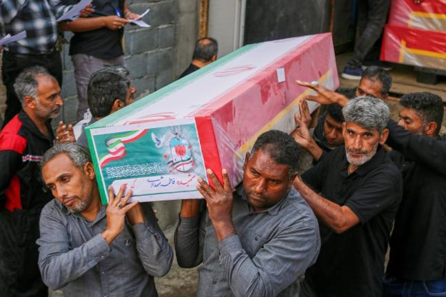 A coffin is carried during the funeral of mostly children killed in what Iranian officials said was an Israeli-US strike February 28 at a girls’ elementary school in Minab, Iran.