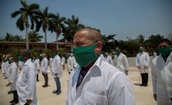 Cuban doctors form up during a farewell ceremony as they get ready to leave Havana to bring their expertise to foreign lands. 