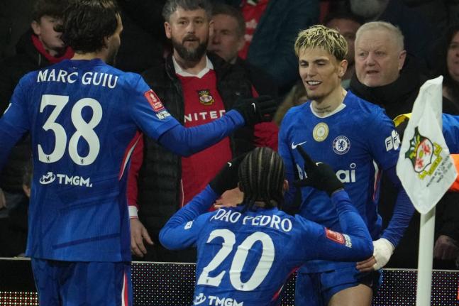 AP Chelsea players, (from left) Marc Gulu, Xoao Pedro, and Garnacho, celebrate after a goal during the fifth round FA Cup football match against Wrexham in Wrexham, Wales, yesterday.