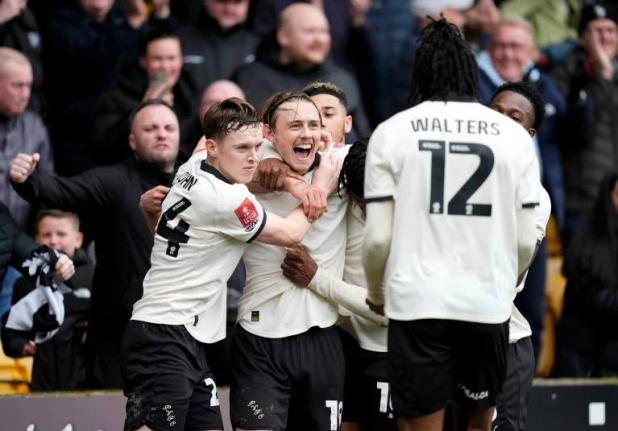 Port Vale’s Ben Waine celebrates with teammates after scoring his side’s first goal of the game, during the FA Cup fifth-round match against Sunderland and Port Vale in Stoke on Trent, England, yesterday.