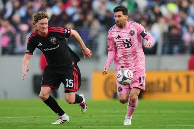 Inter Miami forward Lionel Messi (right) advances past DC United defender Kye Rowles (15) during the first half of an MLS soccer match, Saturday, March 7, 2026, in Baltimore. 