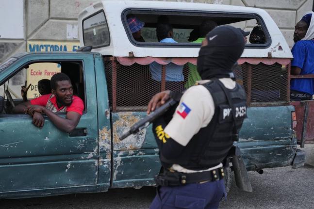 A police officer stands guard in Port-au-Prince, Haiti, Tuesday, March 3, 2026. (AP Photo/Odelyn Joseph)