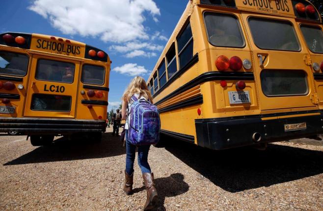 A student prepares to leave school, August 13, 2014, southeast of Brookhaven, Miss. (AP Photo/Rogelio V. Solis, File)