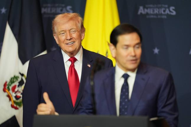 President Donald Trump listens while Secretary of State Marco Rubio speaks at the Shield of the Americas Summit, Saturday, March 7, 2026, at Trump National Doral Miami in Doral, Florida.