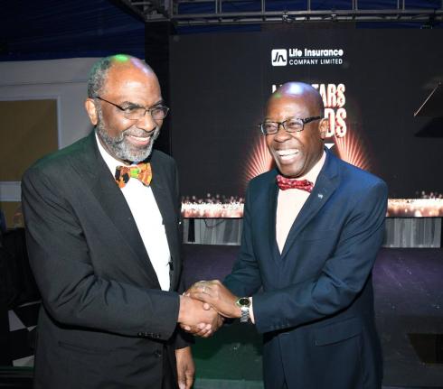 Earl Jarrett (left), chief executive officer of the JN Group, shares a light moment with Hugh Reid, managing director of JN Life Insurance Company, at the company’s ‘Life Stars’ staff awards for 2025, held at the Terra Nova All-Suite Hotel in Kingsto