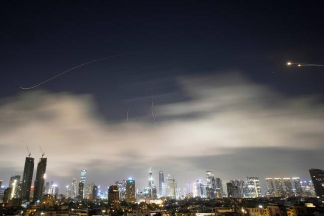 Iranian missiles attack Tel Aviv, Israel, with air defence systems firing to intercept them on Sunday, March 15, 2026. (AP Photo)