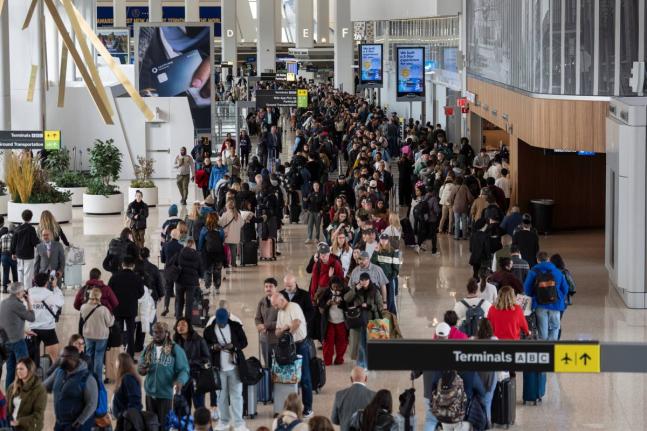 Travellers wait in a TSA line, Wednesday, March 25, 2026, at LaGuardia Airport in New York. (AP Photo/Yuki Iwamura)