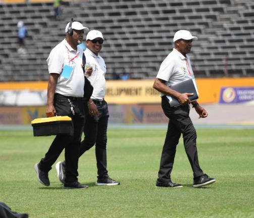 Champs starters at work during the ISSA/GraceKennedy Boys and Girls' Athletics Championships inside the National Stadium, yesterday.
