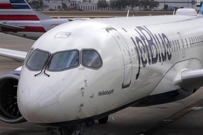 A Jet Blue Airlines jet pushes back from a gate at the Pittsburgh International Airport in Imperial, Pa., February 13, 2026. (AP Photo/Gene J. Puskar, File)