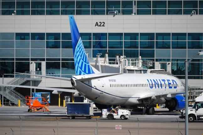 A United Airlines jetliner sits at a gate along the A concourse of Denver International Airport, March 20, 2026, in Denver. (AP Photo/David Zalubowski, File)