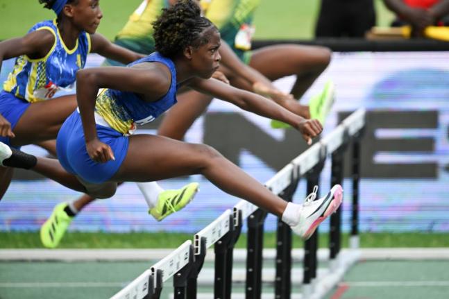 Ricardo Makyn/Chief Photo Editor
Hydel High School’s Keneisha Robinson hurdles on her way to winning the Class Four 70-metre hurdles at the ISSA/GraceeKennedy Boys and Girls’ Athletics Championships inside the National Stadium on March 28. 