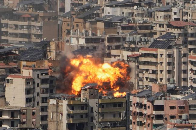 Flames rise from an Israeli airstrike in Beirut suburbs in Lebanon on March 11, 2026. (AP Photo/Hassan Ammar)