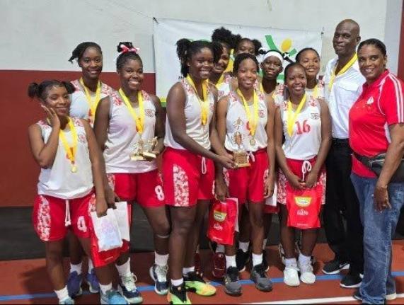 ISSA Urban Area Schoolgirl Basketball MVP Danae Brown (centre) celebrates the title with teammates, Queens alumni Olive McNaughton (right) and coach Donald Bimmer (second right), after they defeated St Andrew High School 49-33 in the ISSA urban area final 