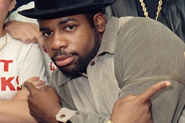 FILE - Run-D.M.C.'s Jason Mizell, Jam-Master Jay, poses with teenagers gathered at New York's Madison Square Garden, Oct. 7, 1986, in New York City. (AP Photo/G. Paul Burnett, File)