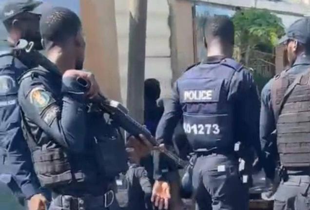 Cops at the scene of a fatal police shooting in West Kingston on July 26. 