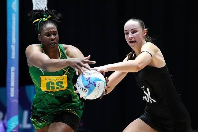 Sunshine Girls goal shooter Romelda Aiken (left) and goalkeeper Kelly Jackson compete for the ball during their Commonwealth Games Pool B netball game inside the Hydro yesterday.
