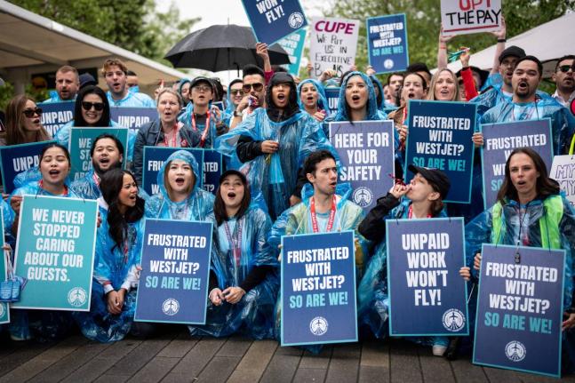 WestJet flight attendants strike at Vancouver International Airport in Richmond, British Columbia, Sunday, Aug. 2, 2026. (Ethan Cairns/The Canadian Press via AP)